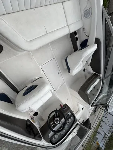 Slide: The Image of 2007 Regal Sport Boat 1900 Bowrider interior with white seating and steering console. - 7