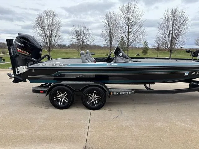 Slide: The Image of 2020 Skeeter ZX250 boat on trailer with Yamaha engine, parked outdoors. - 11