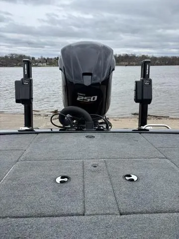 Slide: The Image of 2020 Skeeter ZX250 boat with powerful engine, docked by a lake under cloudy skies. - 19