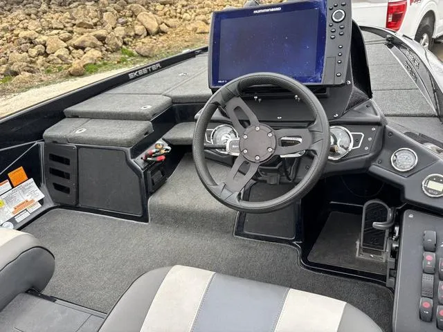 Slide: The Image of 2020 Skeeter ZX250 boat cockpit with steering wheel and navigation system. - 20