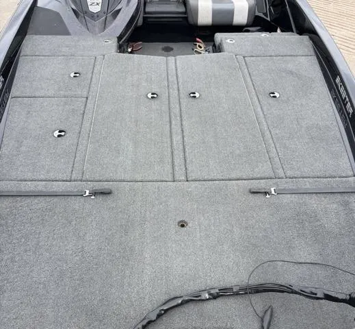 Slide: The Image of 2020 Skeeter ZX250 boat deck with gray carpet and storage compartments. - 8