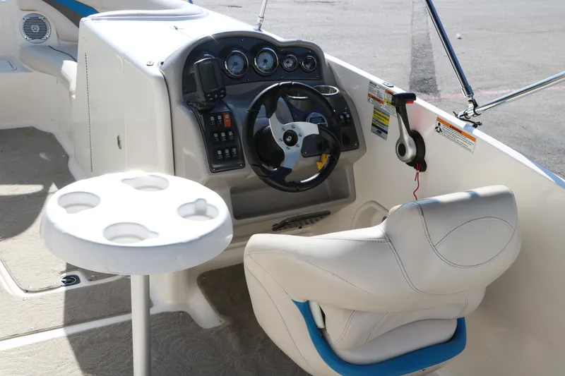 Slide: The Image of 2009 Hurricane FunDeck 226 OB boat cockpit with steering wheel and seating. - 14