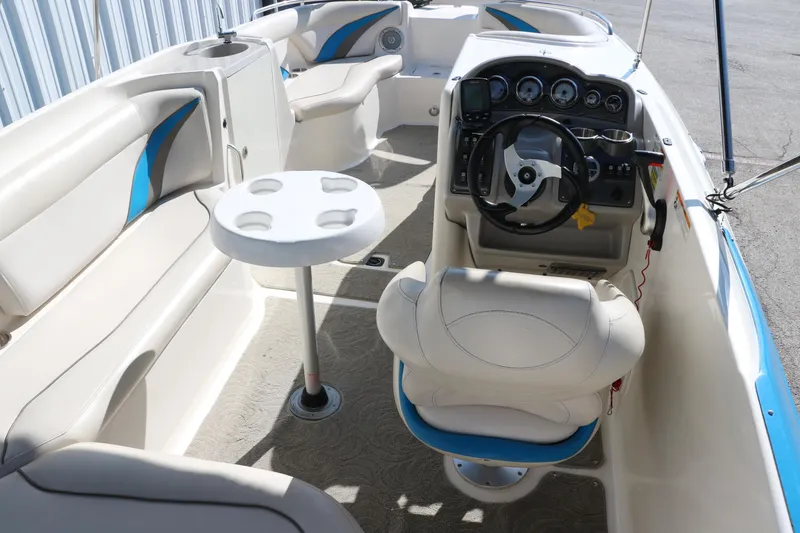 Slide: The Image of 2009 Hurricane FunDeck 226 OB boat interior with seating, steering console, and table. - 16