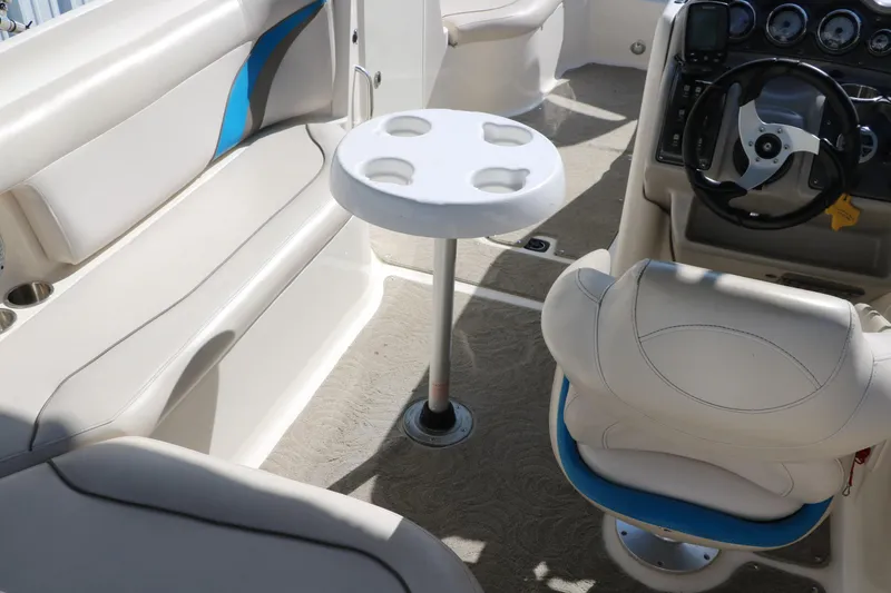 Slide: The Image of 2009 Hurricane FunDeck 226 OB interior with seating, table, and steering console. - 17