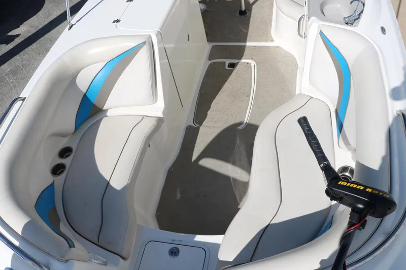 Slide: The Image of 2009 Hurricane FunDeck 226 OB interior with white and blue seating, spacious layout. - 20