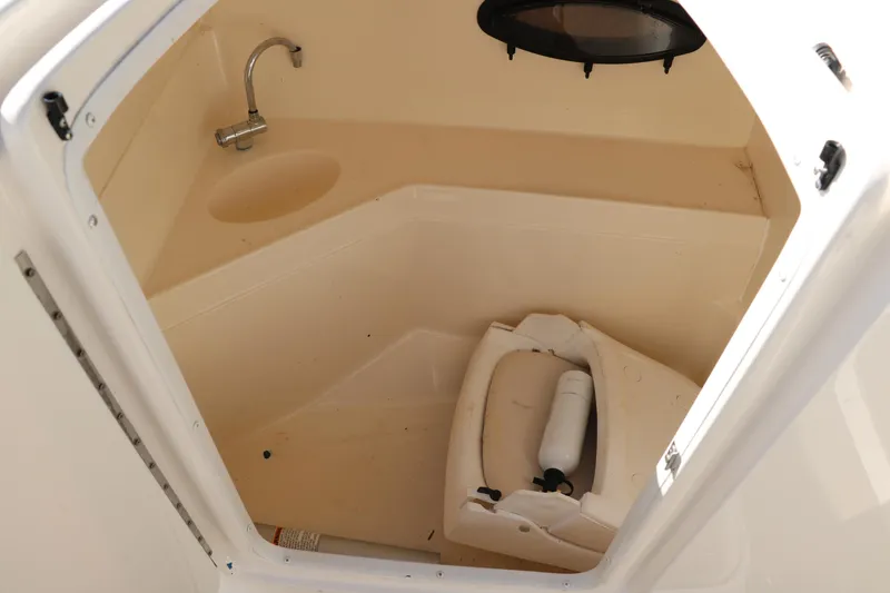 Slide: The Image of 2009 Hurricane FunDeck 226 OB boat interior with sink and storage area. - 23