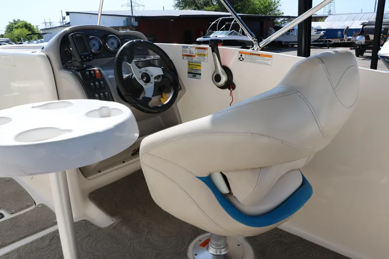 Slide: The Image of 2009 Hurricane FunDeck 226 OB boat cockpit with steering wheel and captain's chair. - 24