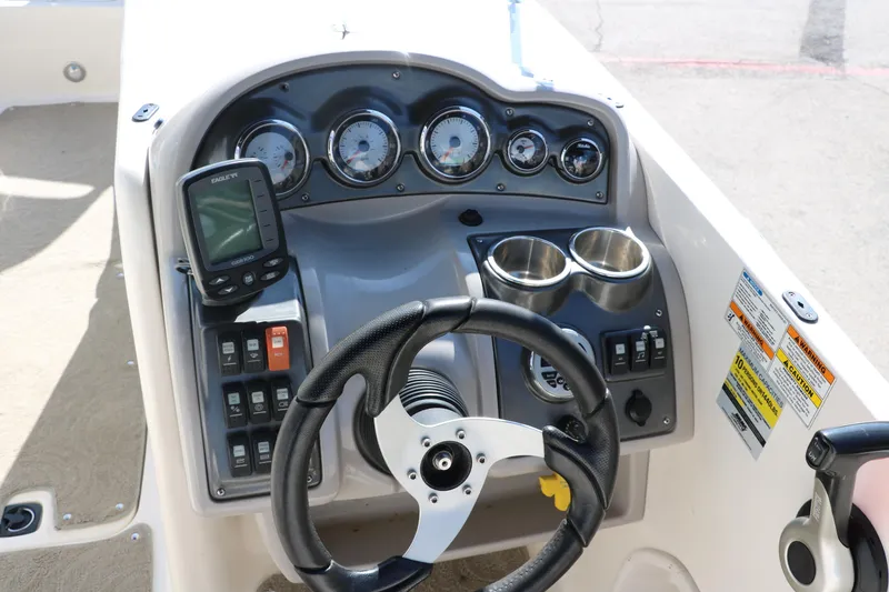 Slide: The Image of 2009 Hurricane FunDeck 226 OB boat dashboard with steering wheel and gauges. - 28