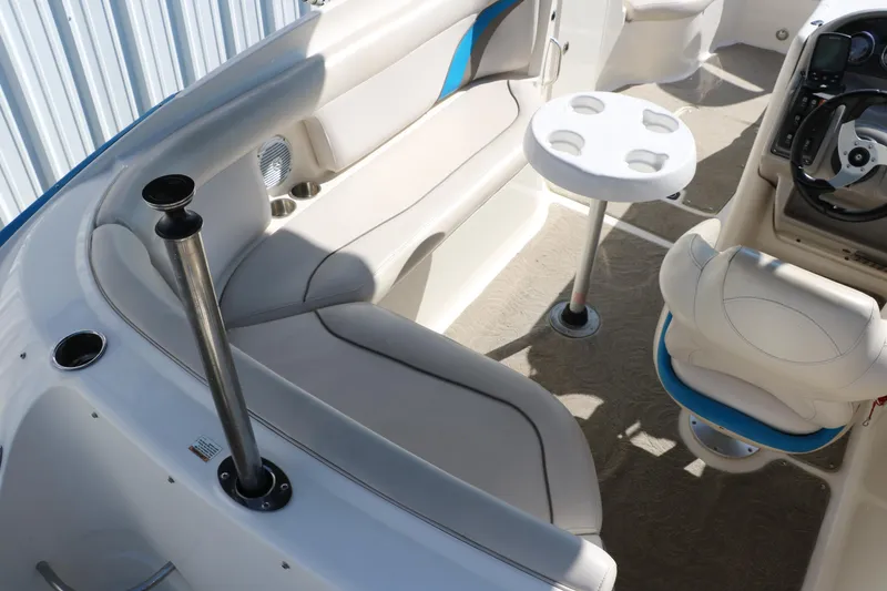 Slide: The Image of 2009 Hurricane FunDeck 226 OB interior with seating, table, and steering console. - 31