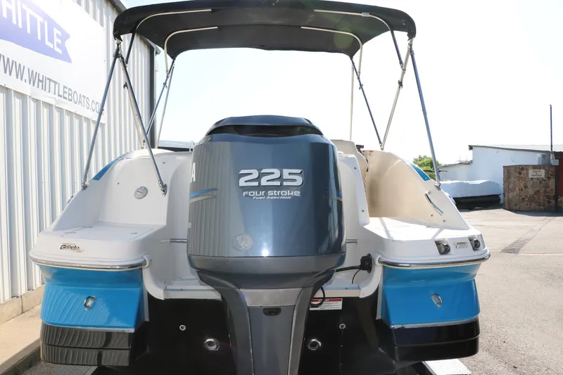 Slide: The Image of 2009 Hurricane FunDeck 226 OB boat with 225 horsepower outboard motor, docked outdoors. - 4