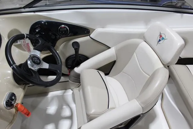 Slide: The Image of 2007 Campion Allante 545i BR boat interior with steering wheel and beige seating. - 25