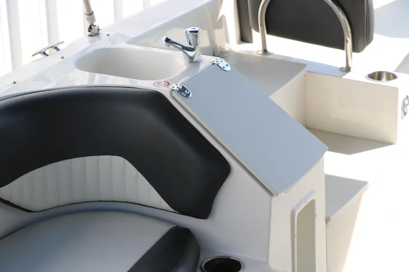 Slide: The Image of 2018 Stingray 212 SC boat interior with seating and sink. - 20