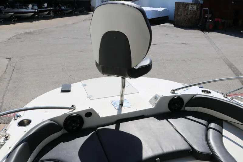 Slide: The Image of 2018 Stingray 212 SC boat interior with seating and speakers. - 24