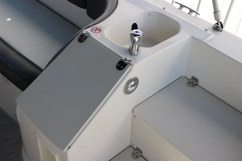 Slide: The Image of 2018 Stingray 212 SC boat interior with seating and storage compartments. - 28