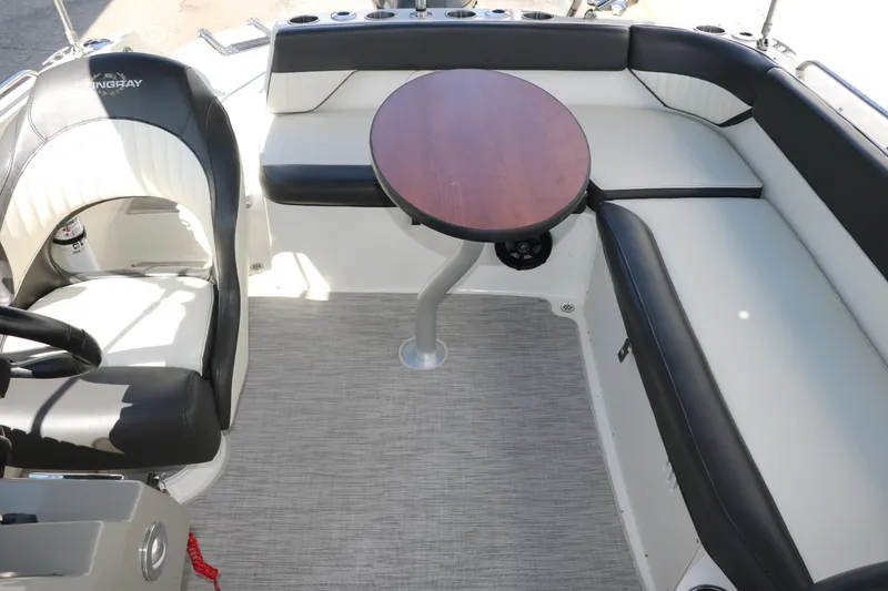 Slide: The Image of 2018 Stingray 212 SC boat interior with seating and round table. - 31