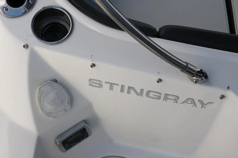 Slide: The Image of 2018 Stingray 212 SC boat interior with logo and cup holder. - 41