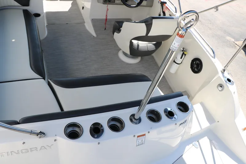 Slide: The Image of 2018 Stingray 212 SC boat interior with seating and cup holders. - 42