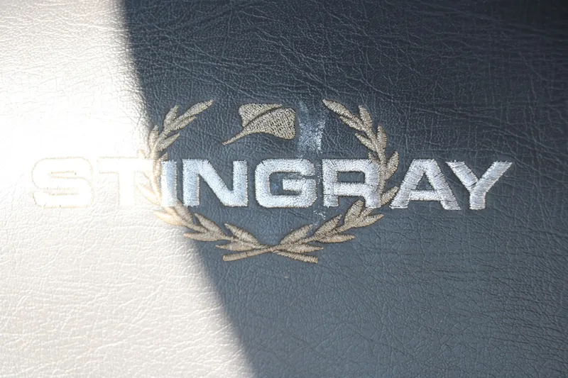 Slide: The Image of Stingray 212 SC 2018 logo on textured surface with laurel wreath design. - 44