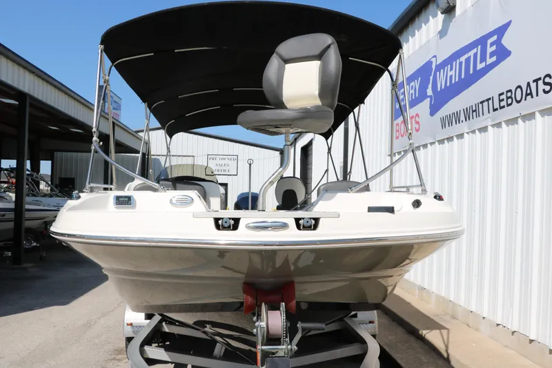 Slide: The Image of 2018 Stingray 212 SC boat on trailer, under canopy, at dealership. - 9