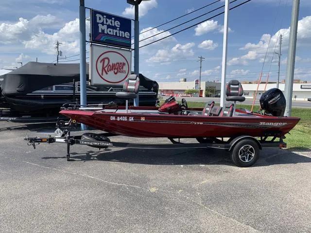 Slide: The Image of 2023 Ranger RT178 boat displayed at Dixie Marine dealership under a clear sky. - 1