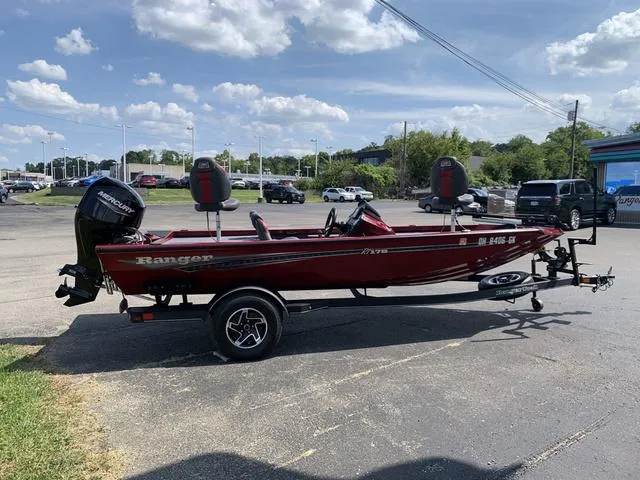 Slide: The Image of 2023 Ranger RT178 boat on trailer in parking lot under blue sky. - 3