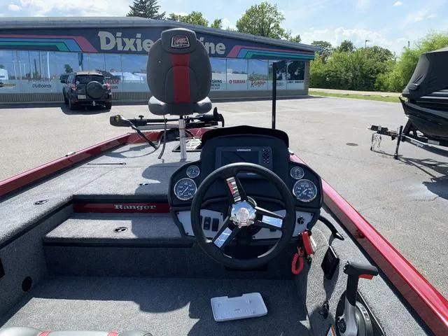 Slide: The Image of 2023 Ranger RT178 boat interior with steering wheel and seating at dealership. - 4