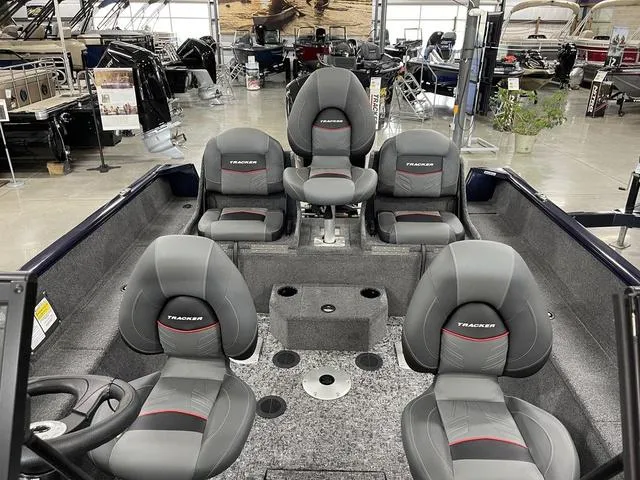 Slide: The Image of 2025 Tracker Pro Guide™ V-175 Combo boat interior with five gray seats in a showroom. - 15