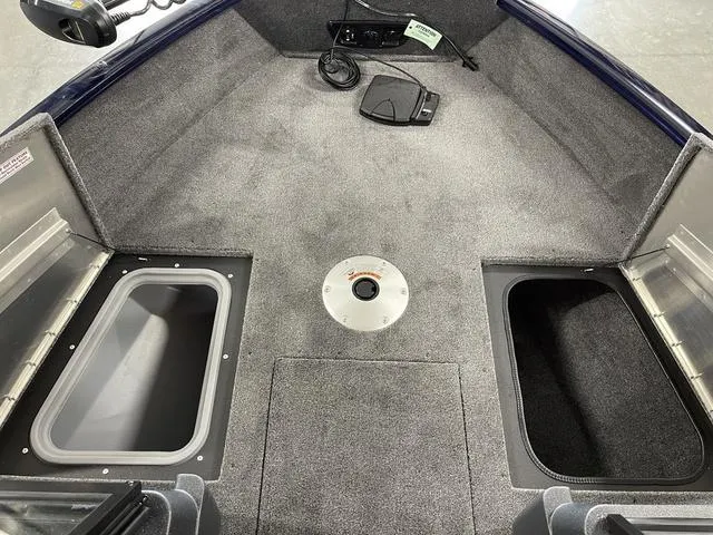 Slide: The Image of 2025 Tracker Pro Guide™ V-175 Combo boat interior with storage compartments and carpeted flooring. - 16