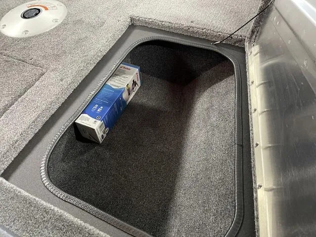 Slide: The Image of 2025 Tracker Pro Guide™ V-175 Combo storage compartment with a packaged item inside. - 18