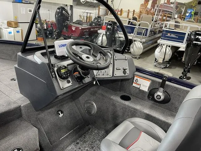Slide: The Image of 2025 Tracker Pro Guide V-175 Combo boat interior with steering wheel and controls. - 21