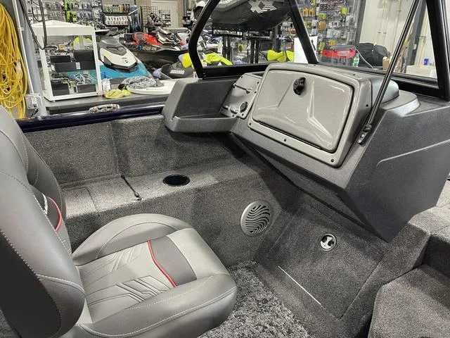 Slide: The Image of Interior of 2025 Tracker Pro Guide V-175 Combo boat, featuring gray seating and dashboard. - 26
