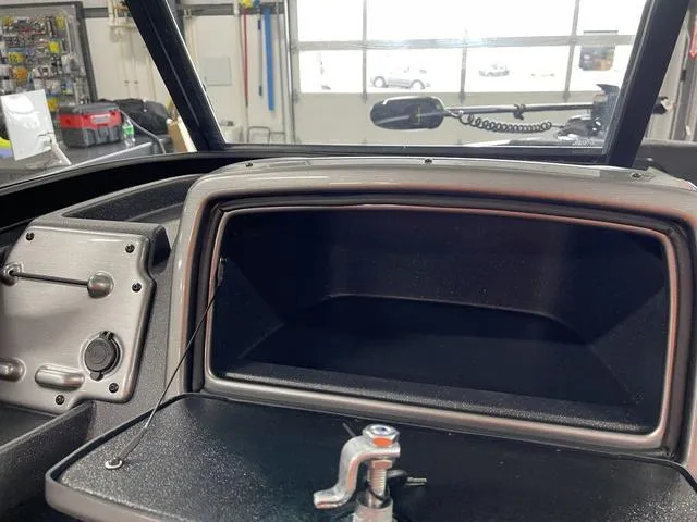 Slide: The Image of 2025 Tracker Pro Guide V-175 Combo dashboard with open storage compartment. - 27