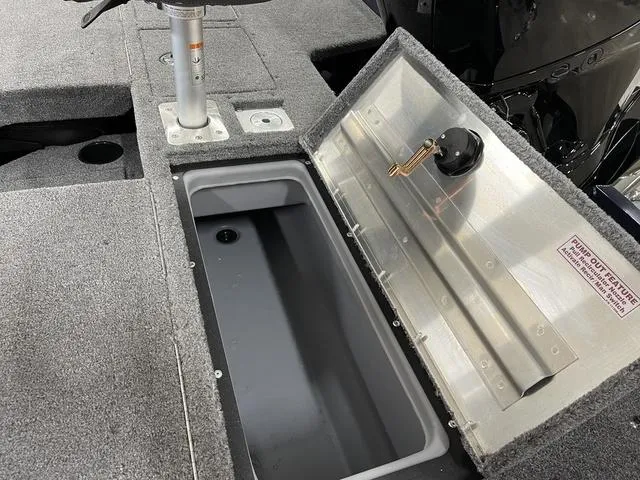 Slide: The Image of 2025 Tracker Pro Guide V-175 Combo boat storage compartment with open lid and gray interior. - 31
