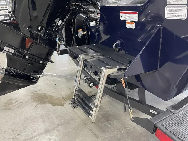 Slide: The Image of 2025 Tracker Pro Guide™ V-175 Combo boat with a foldable ladder and motor detail. - 5