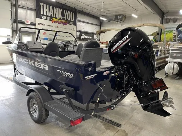 Slide: The Image of 2025 Tracker Pro Guide V-175 Combo boat with Mercury engine in showroom. - 6