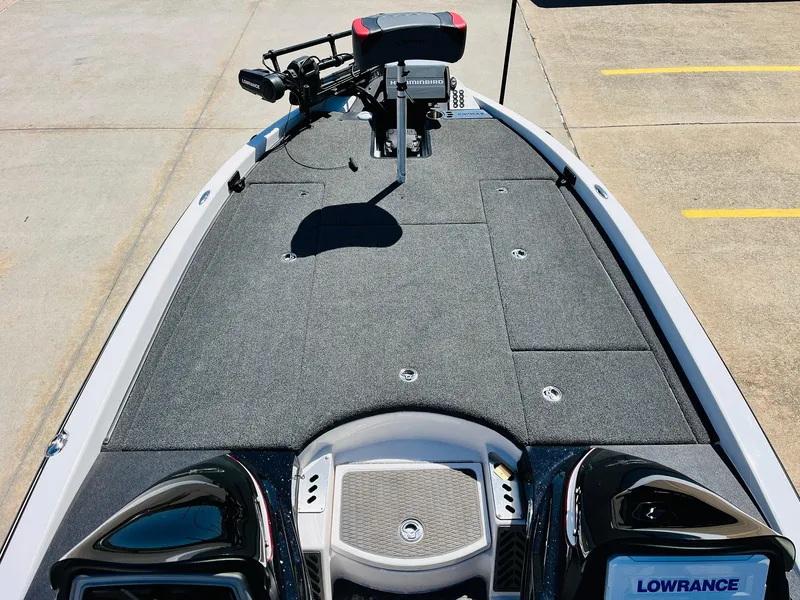 Slide: The Image of 2022 Caymas CX 21 PRO boat deck with Lowrance equipment, featuring a spacious, carpeted layout. - 12