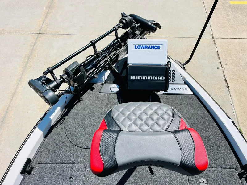 Slide: The Image of 2022 Caymas CX 21 PRO boat with Lowrance and Humminbird electronics, featuring a red and gray seat. - 13