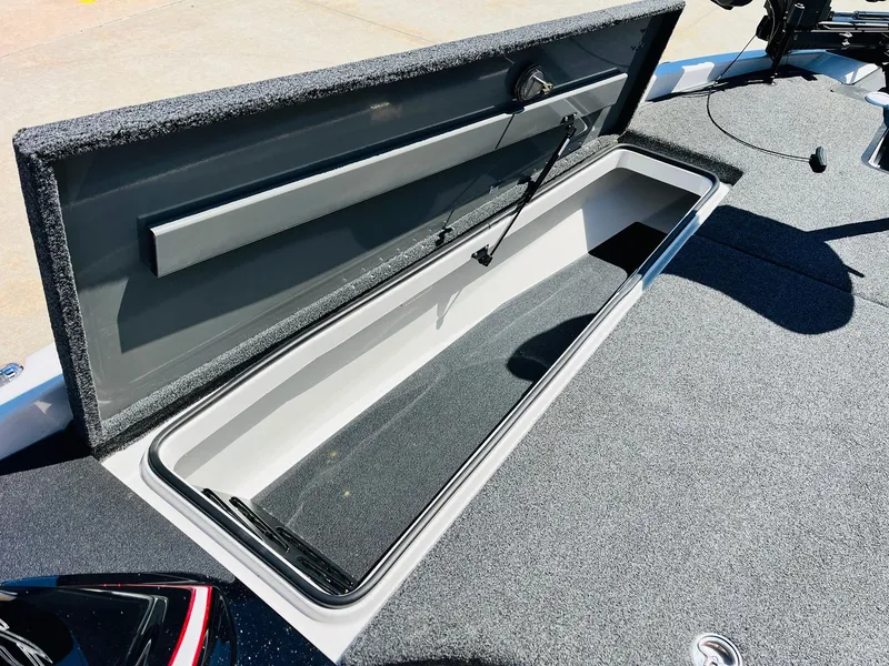 Slide: The Image of 2022 Caymas CX 21 PRO boat storage compartment with open lid, showcasing interior space. - 20