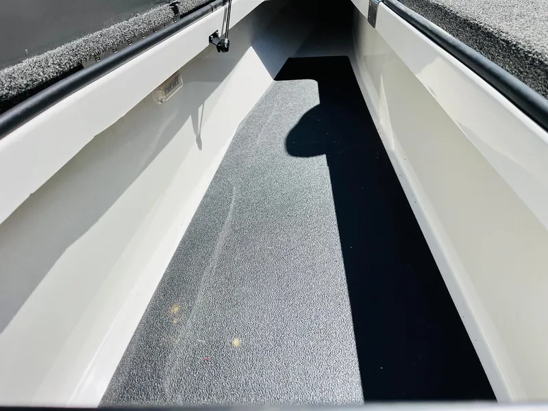 Slide: The Image of 2022 Caymas CX 21 PRO boat interior storage compartment with carpeted flooring. - 21