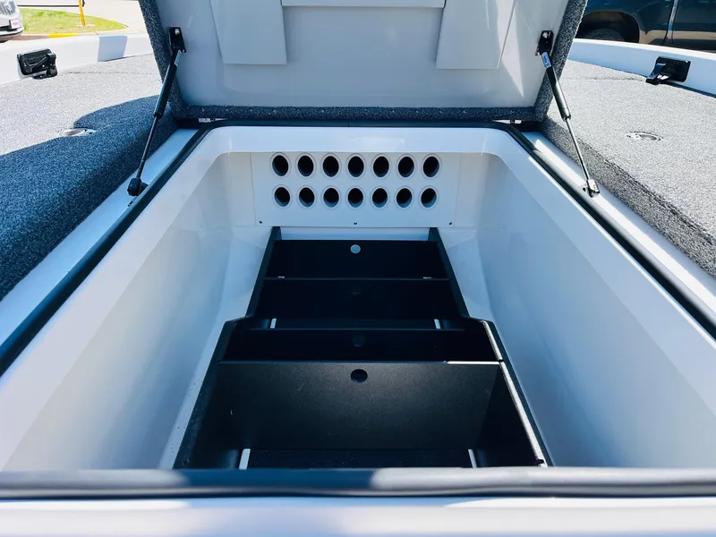Slide: The Image of 2022 Caymas CX 21 PRO boat storage compartment with organized dividers and ventilation holes. - 23