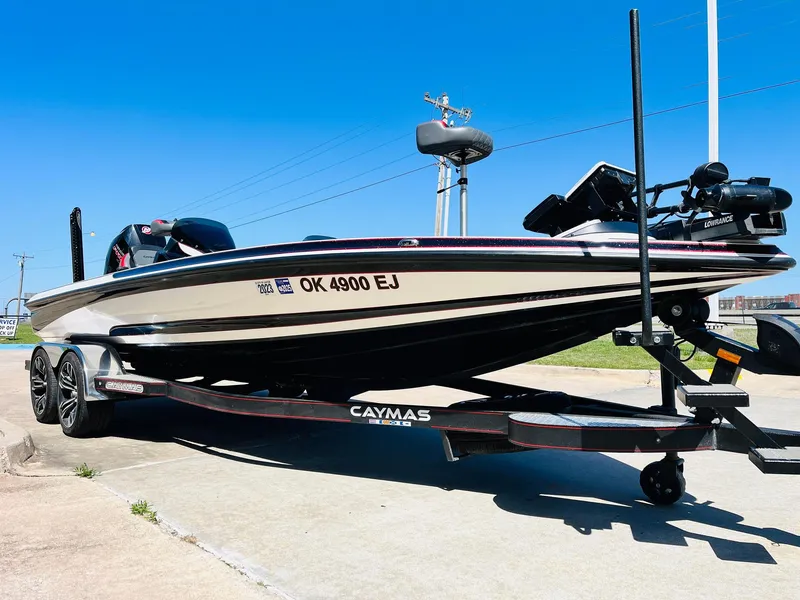 Slide: The Image of 2022 Caymas CX 21 PRO boat on trailer, parked outdoors under clear blue sky. - 3