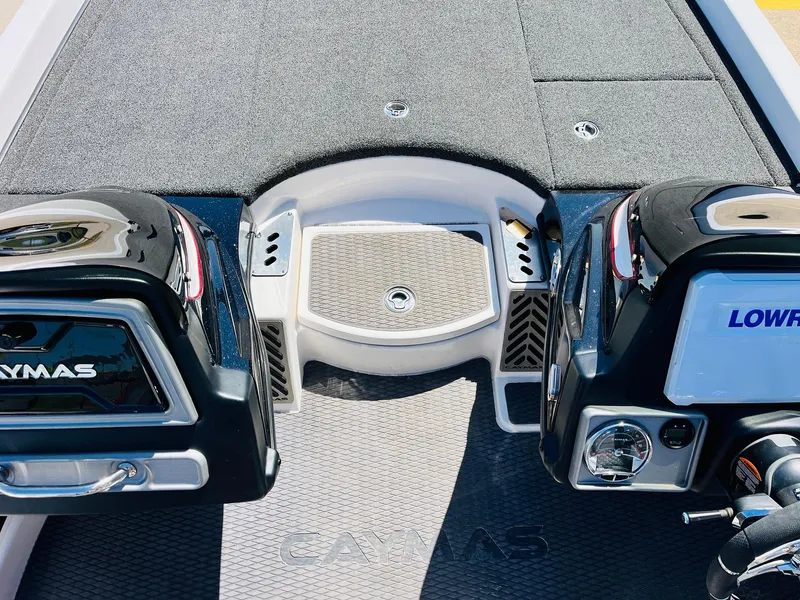 Slide: The Image of 2022 Caymas CX 21 PRO boat deck with dual Lowrance units and carpeted flooring. - 32