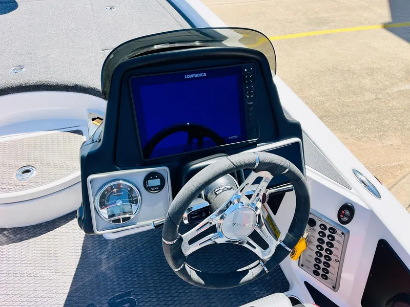 Slide: The Image of 2022 Caymas CX 21 PRO boat dashboard with steering wheel and digital display. - 41