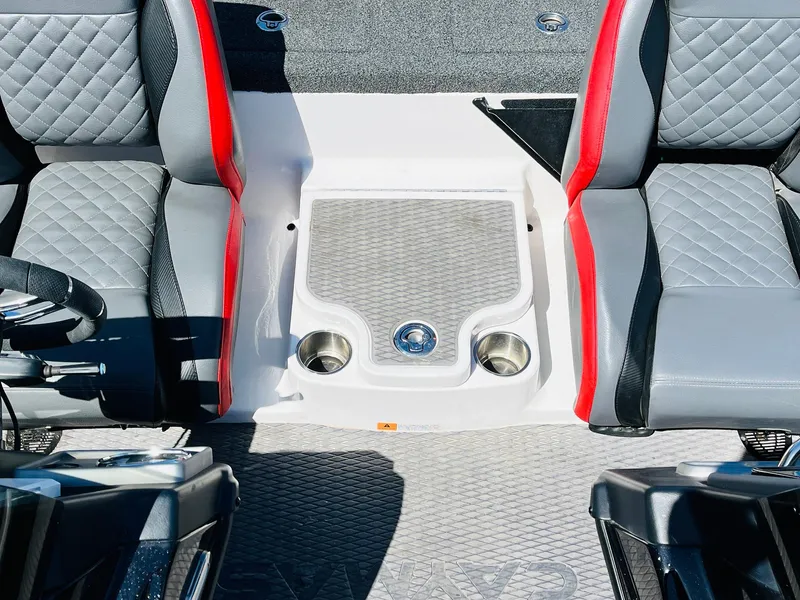 Slide: The Image of 2022 Caymas CX 21 PRO boat interior with quilted seats and cup holders. - 48