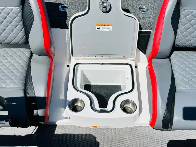 Slide: The Image of 2022 Caymas CX 21 PRO boat interior with storage compartment and cup holders. - 49