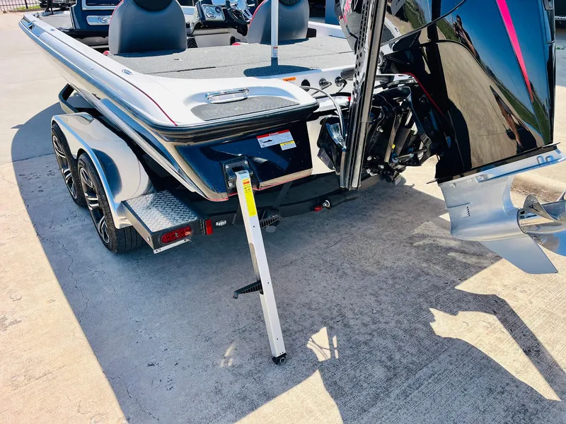 Slide: The Image of 2022 Caymas CX 21 PRO boat rear view with motor and trailer. - 8