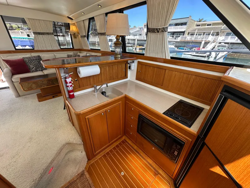 Slide: The Image of Luxurious interior of 1998 Riviera 43 Open Flybridge yacht with modern kitchen amenities. - 8
