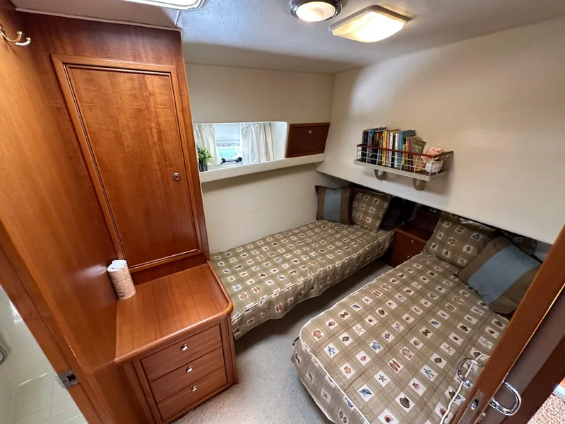 Slide: The Image of Twin cabin with wooden furnishings in 1998 Riviera 43 Open Flybridge yacht. - 9