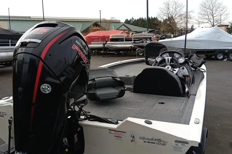 Slide: The Image of 2022 Tracker Pro Team 190 TX boat with Mercury engine, parked outdoors. - 3