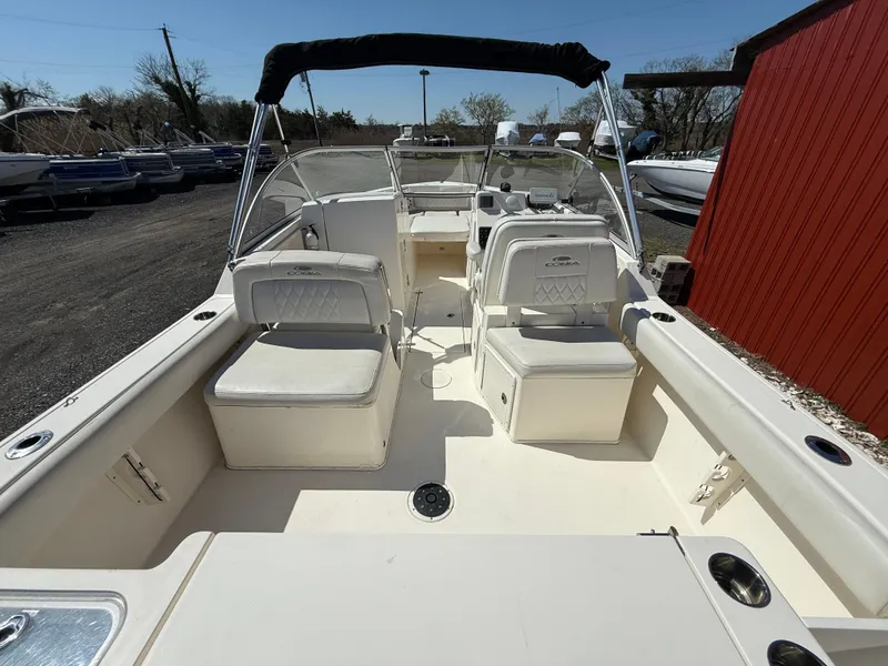 Slide: The Image of 2023 Cobia 220 Dual Console boat with spacious seating and sleek design. - 9